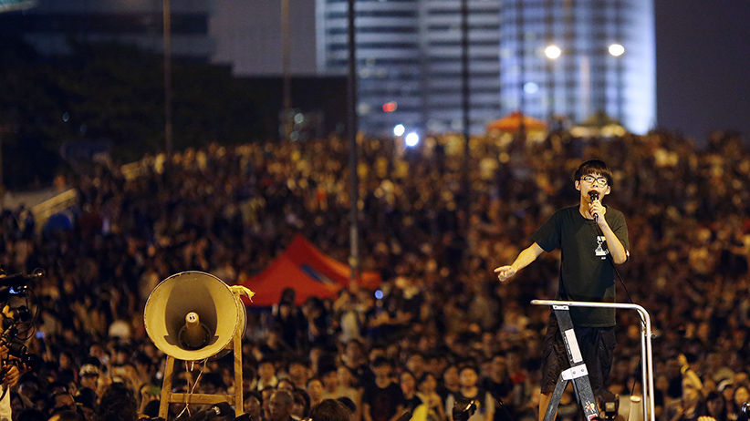 Joshua Wong, leader of the student movement, delivers a speech as protesters block the main street to the financial Central district in Hong Kong